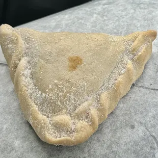 a piece of pie with powdered sugar on top