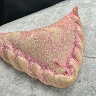 a pink pastry on a table