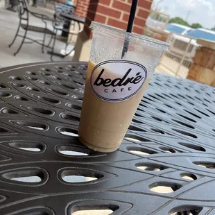 a cup of iced coffee on a table