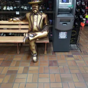 a statue of a man sitting on a bench