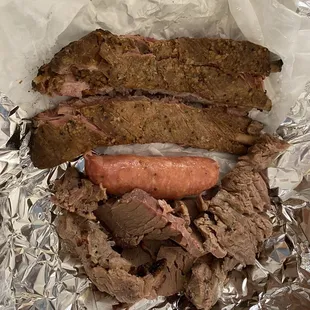 Pork ribs, brisket, and a link of sausage.