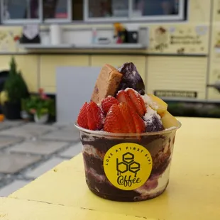 an ice cream sundae with strawberries and chocolate