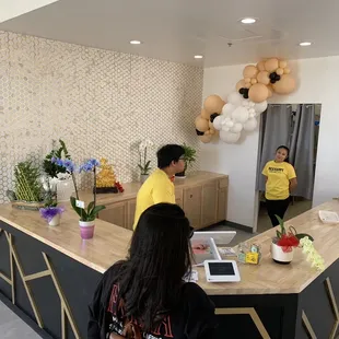 two people standing at a counter