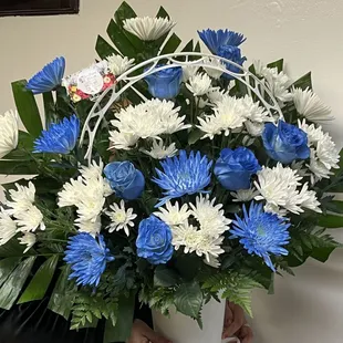 Funeral arrangement blue rose and blue flowers and white flowers