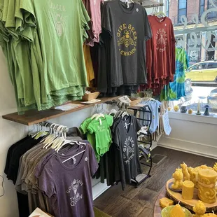 a variety of t - shirts on display in a store