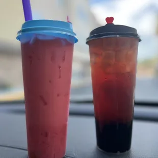 two cups of boba on a car dashboard