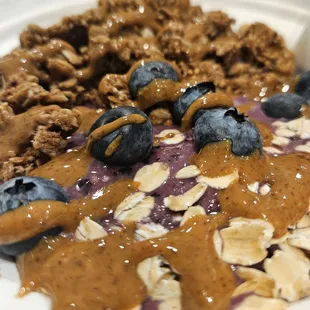 a plate of oatmeal with blueberries and nuts