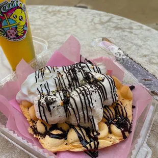 a waffle with ice cream and chocolate drizzle