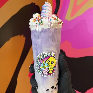 Taro Milk Tea with boba, whip crème , sprinkles and a unicorn meringue cookie on top!