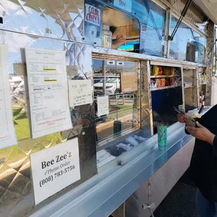 a woman ordering food from a food truck