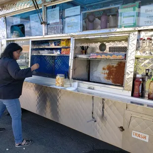a woman ordering food from a food truck