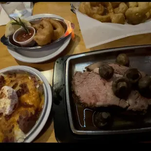 Prime rib with mushrooms on top, smashed red potatoes and 3 shrimp