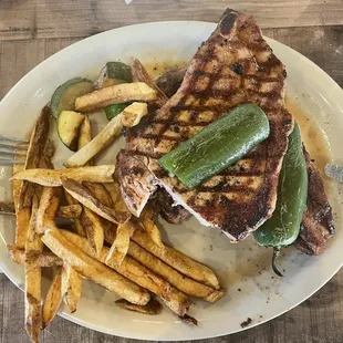 Pork chops with fries, zucchini and jalapeños