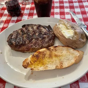 12 oz ribeye with baked potato and bread. Get the baked sweet onion on the side.