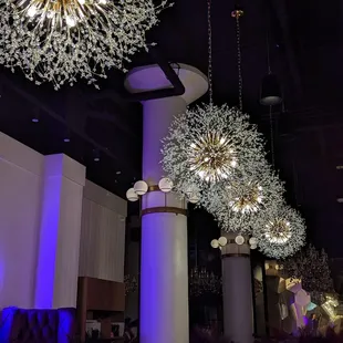 chandeliers hanging from the ceiling in a restaurant