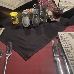 a table setting with utensils and napkins