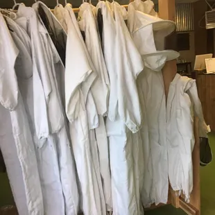 a rack of white shirts