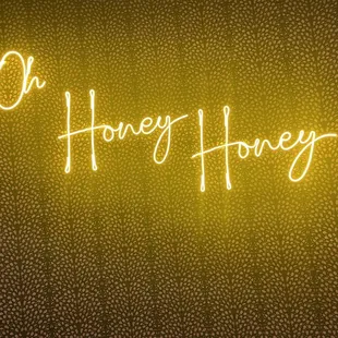 a neon sign that says oh honey