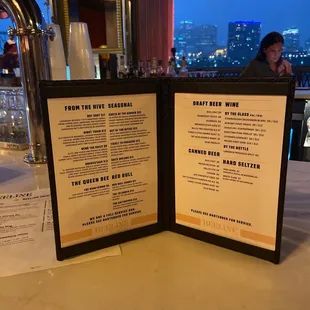 a menu for a restaurant with a view of the city
