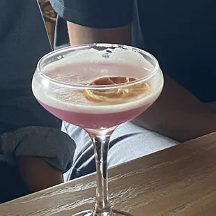 a close up of a cocktail in a coupe glass