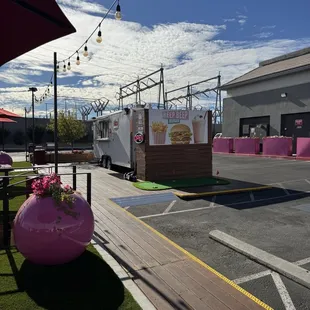 Front of the business with the nicely done walk way and partial view of the grassy area/turf where all the seating is located.