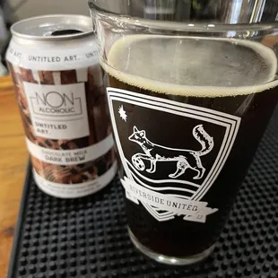 a pint glass and a can of coffee