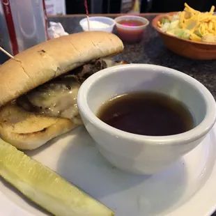 a sandwich and a pickle on a plate