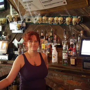 a woman behind a bar counter