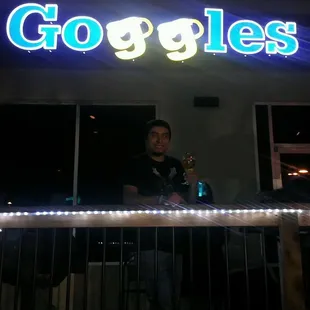 a man standing in front of a bar