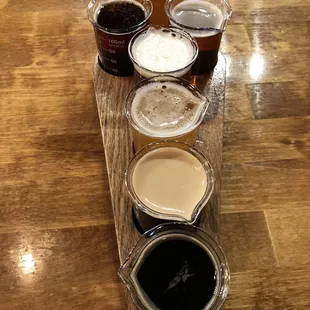 Beer flight of 7 served in a coffin holder &amp; beaker glasses
