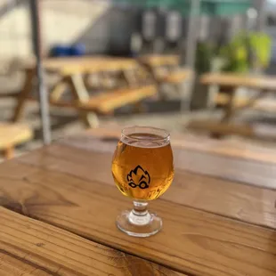 a glass of beer on a wooden table