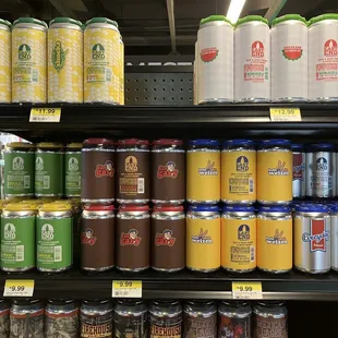 a man standing in front of a shelf of cans