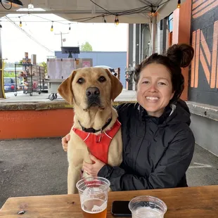 a woman sitting at a table with a dog