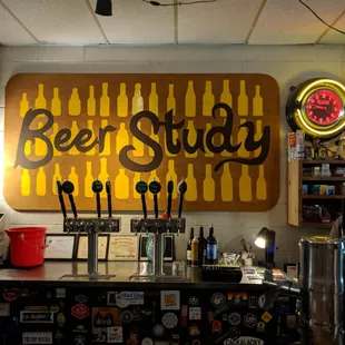 a bar with beer taps and neon signs