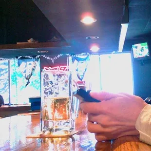 a person using a cell phone at a bar