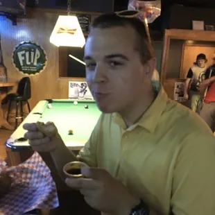 a man sitting at a pool table