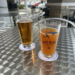 two glasses of beer on a table