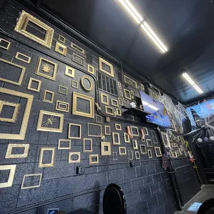 a wall of gold frames
