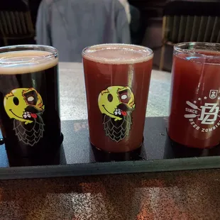 Three flight-sized pours of various beers.
