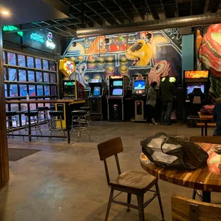 people playing video games in a bar