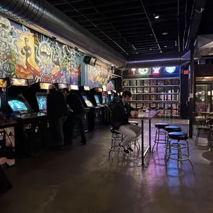 people playing video games in a bar