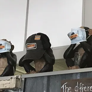 three mannequins wearing hats