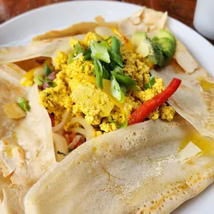 Basic breakfast crepe with scrambled tofu, vegan cheddar, sauteed vegetables, and avocado