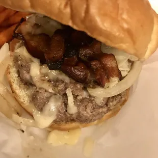 a hamburger with onions and bacon