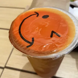 a smiley face on a plastic cup