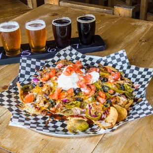 a plate of nachos and beer