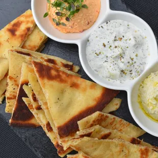 Trio of Dips - artichoke hummus, tzatziki, spicy hipiti, and toasted pita.