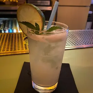 a glass of lemonade with a slice of lime