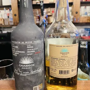 two bottles of alcohol on a bar counter