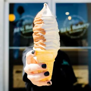 a woman holding a cone of ice cream